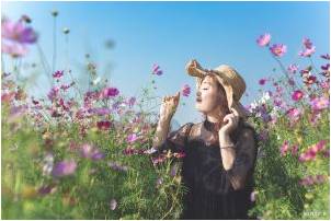 A woman in a field of purple flowers thinking about home renovation ideas for spring 2021