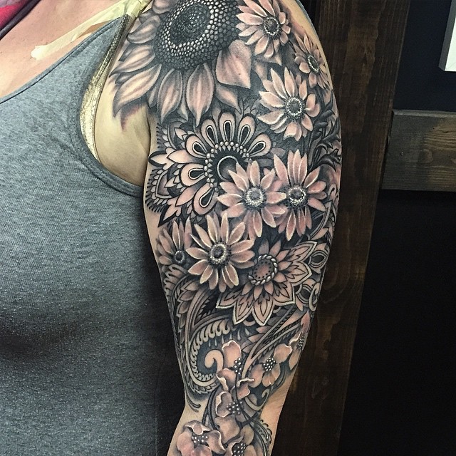 A floral themed tattoo covering the whole shoulder