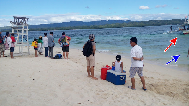 passengers waiting to board the boat going back to mainland from Canigao Island in Matalom, Leyte