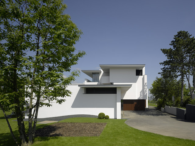 Photo of front facade of an amazing home as seen from the lawn