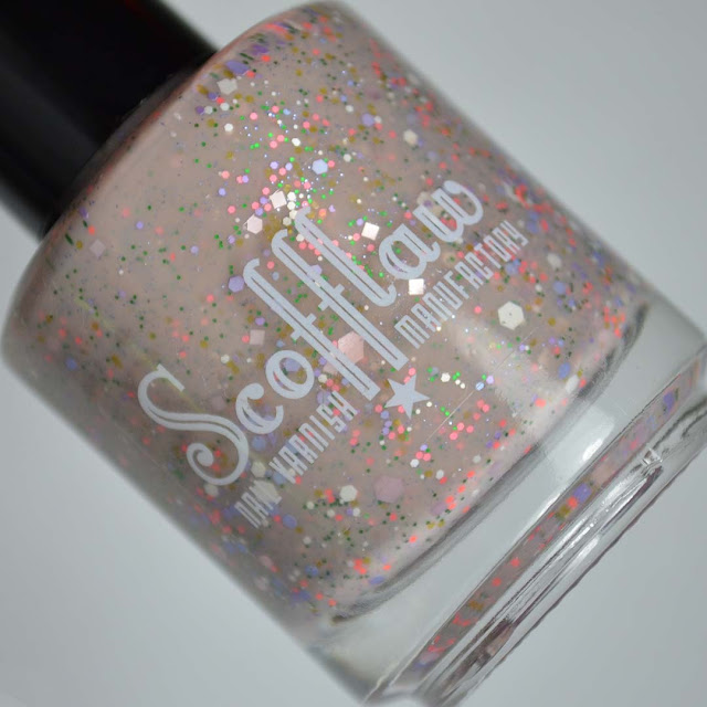 nude nail polish with 60's inspired glitter mix in a bottle