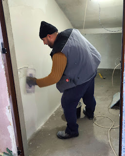 Halil starts plastering for the day