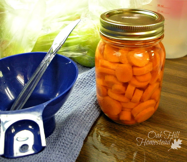 A jar of carrots with canning tools