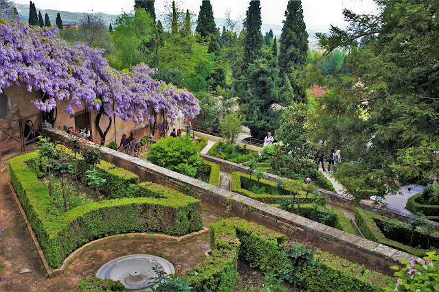 Jardín en terrazas en la ladera de una colina, con diseño, flores y bien cuidado.