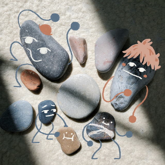 A collection of differently sized pebbles are drawn over to look like little people.