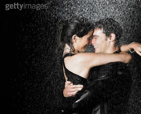 romantic couple kissing in the rain. kissing, hugging and