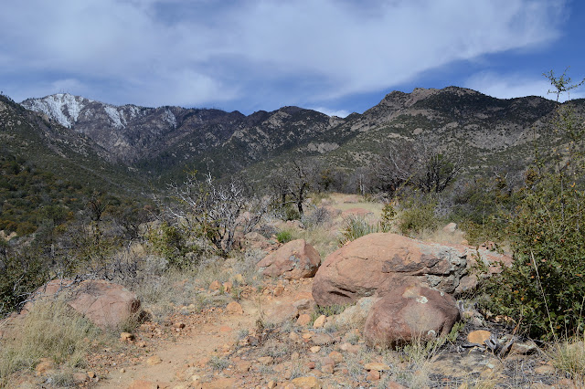 big rock along the trail with Heliograph Peak in view