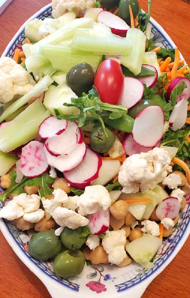 this is a dish of fresh cut up garden vegetables for a Greek Salad