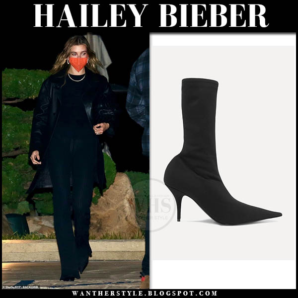 Hailey Bieber in black coat, black pants and black boots
