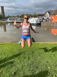 Me in a USA flag running outfit jumping in front of a river.