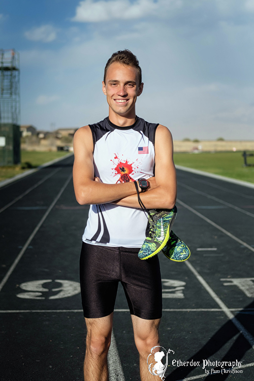 Professional portrait of a high school senior guy at the track