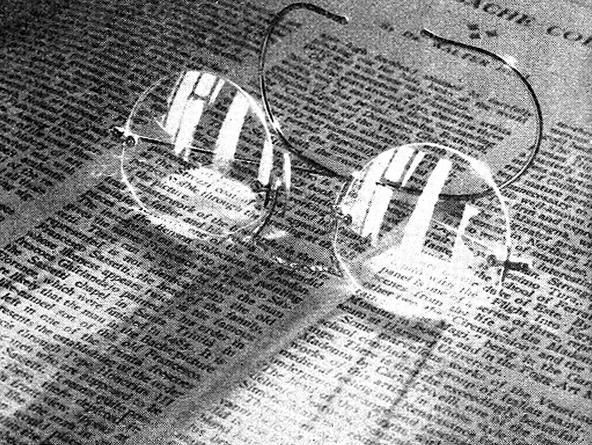 A old photograph of glasses on a newspaper