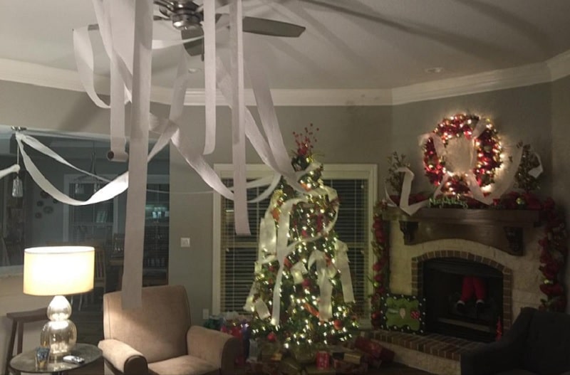 elf covered living room in toilet paper