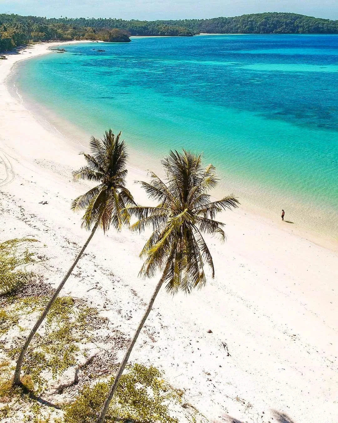 Gumasa Beach white san beach blue waters walking tourist palm trees