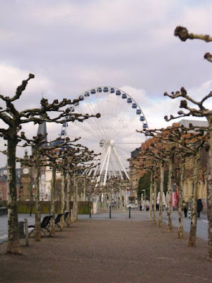 Big wheel at the end of a corridor of knobbly trees