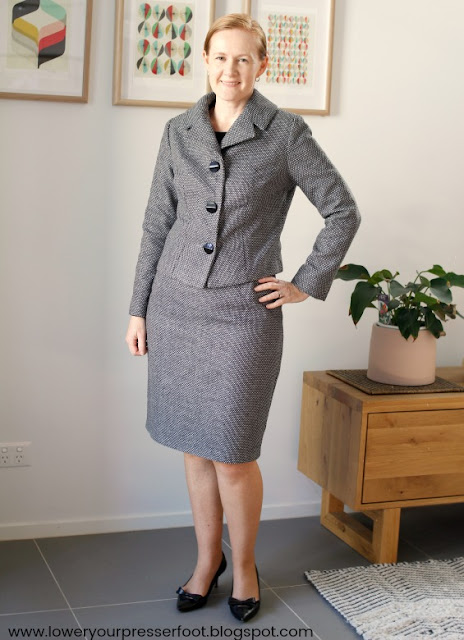 lady posing in a handmade grey skirt suit