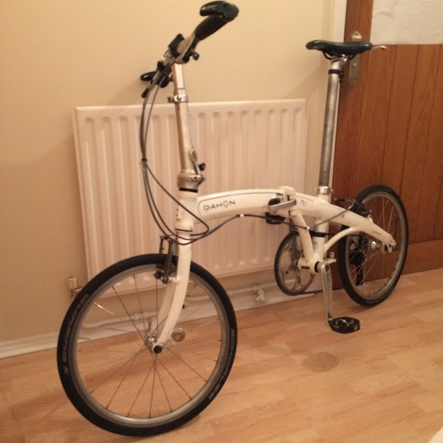 Side view of white Dahon mu p8 indoors