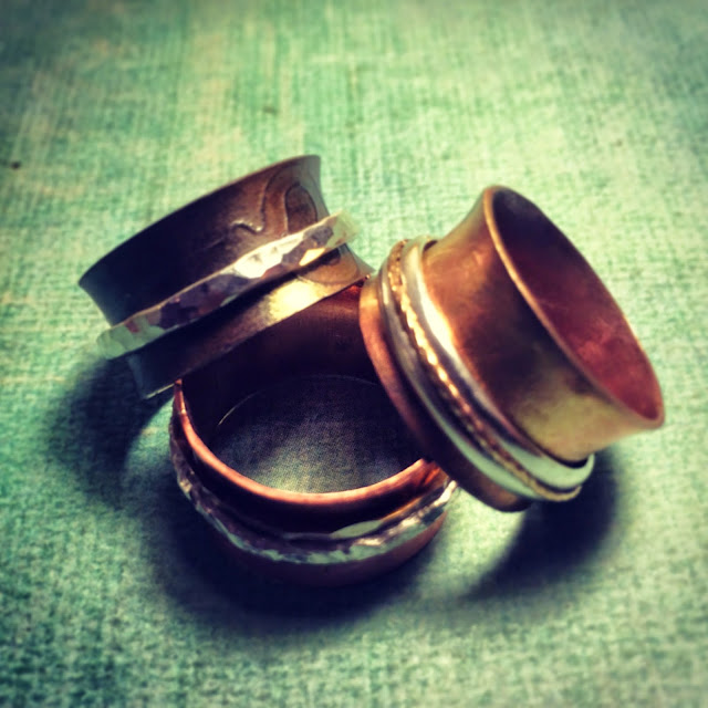 Copper spinner rings with key embossing and silver spinners