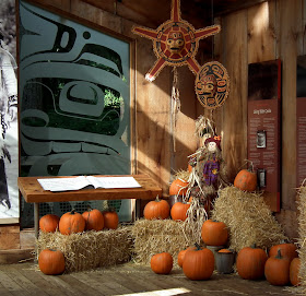 Fall- themed decorations:  pumpkins, hay, corn-shock, scarecrows at Capilano Suspension Bridge Park, Vancouver