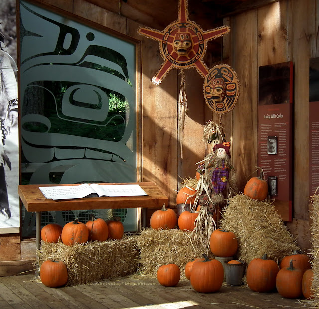 Fall- themed decorations:  pumpkins, hay, corn-shock, scarecrows at Capilano Suspension Bridge Park, Vancouver