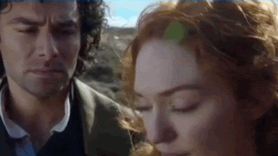 Ross Poldark approaching and then tenderly kissing Demelza's forehead on a cliff edge