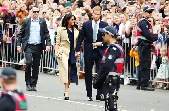 Meghan Markle wore a folded sail dress by Australian fashion designer Dion Lee, Martin Grant coat, Gucci Sylvie bag, Manolo Blahnik suede pumps