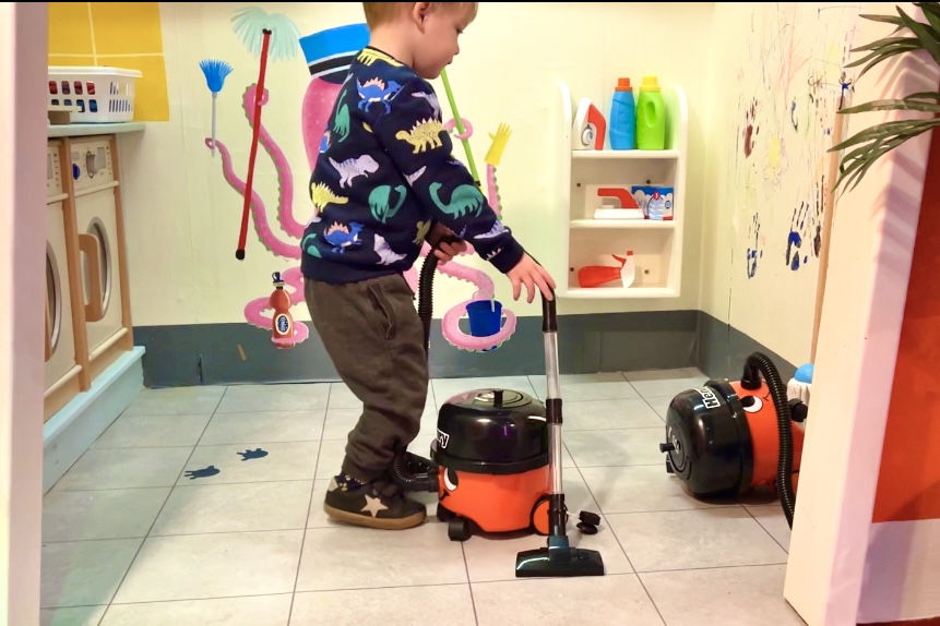 A child cleaning with play toys