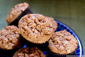 a stack of whole wheat pear and pecan streusel muffins on a plate