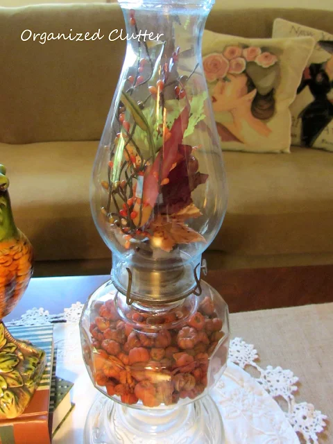 Putka Pods in the base of an oil lamp, Floral pick in chimney