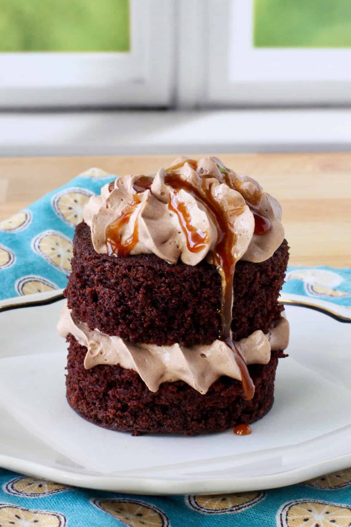 Chocolate-Espresso Cake with frosting and caramel on a plate.