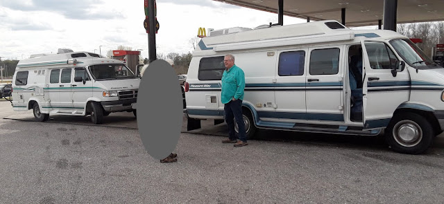 Two Pleasureway vans at gas station