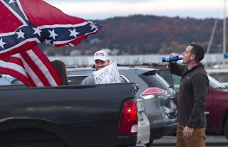 Michigan Police Officer Suspended After Driving With Confederate Flag At ‘Love Trumps Hate’ Rally 