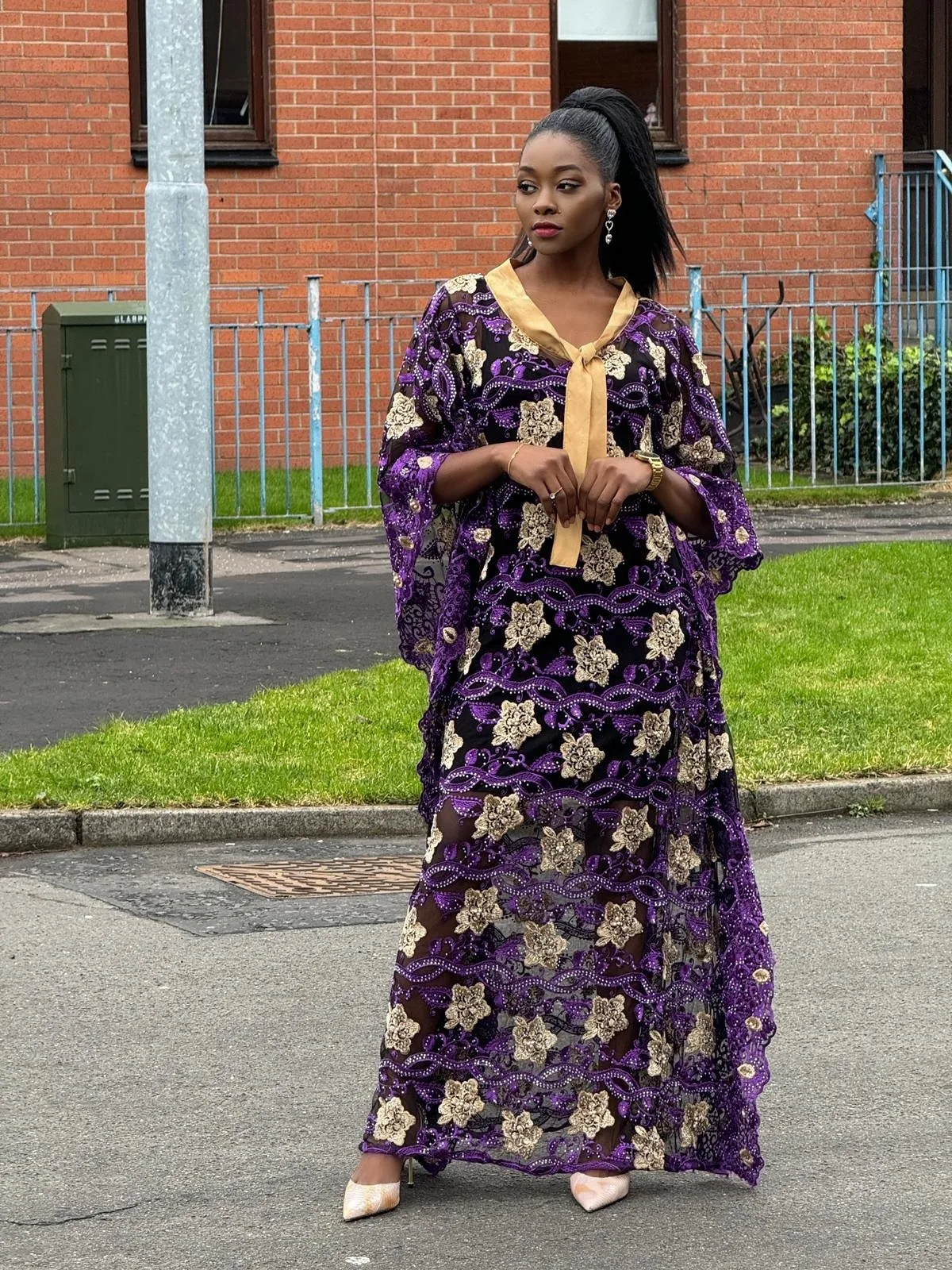 custom-made purple and gold floral embroidered see-through lace dress lined with silver stones.