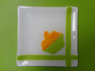 Photo of a fused glass plate with the pattern of a orange cup cake.