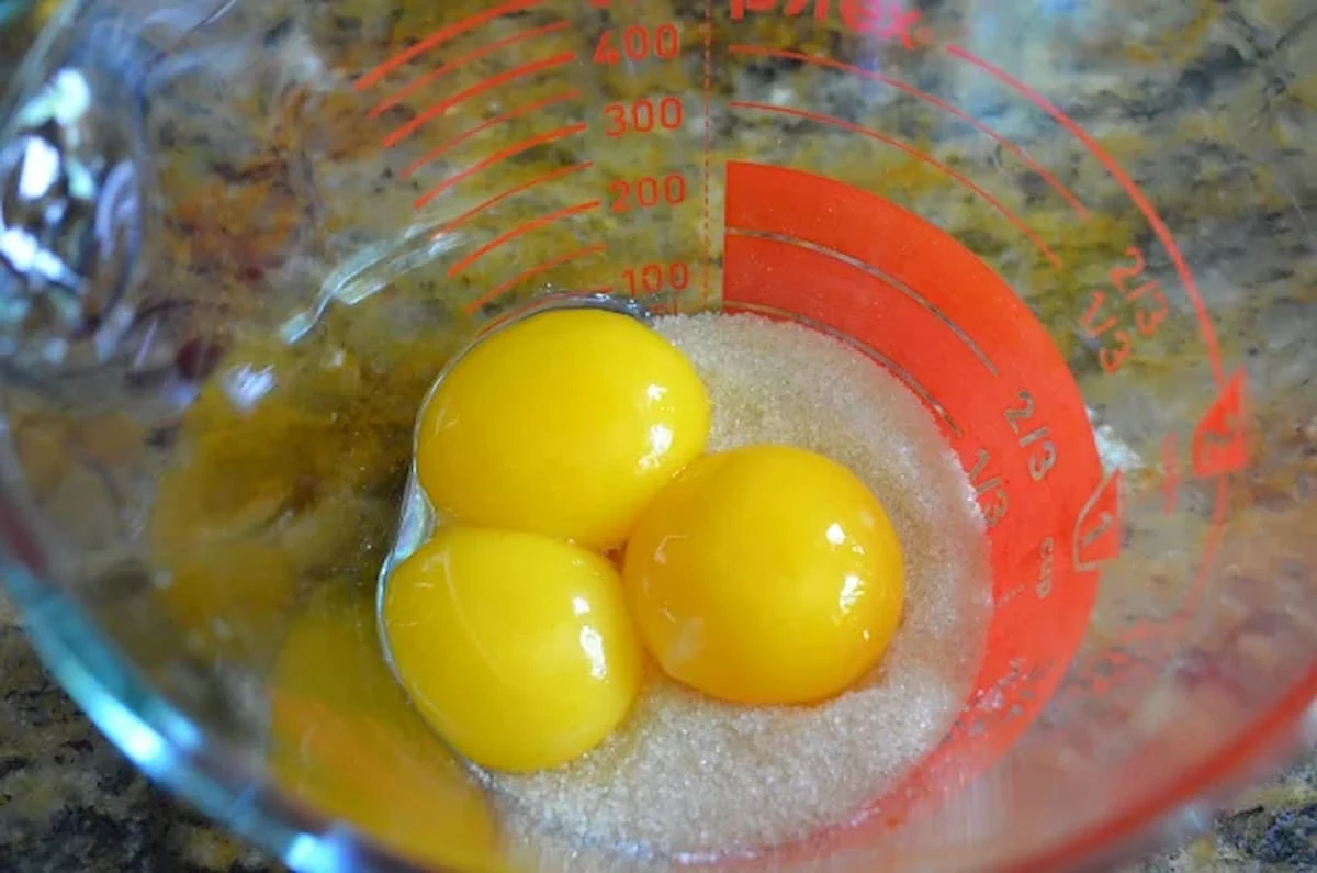 Eggs and Sugar in a glass measuring cup for Caramel Ice Cream with Caramel Swirl.