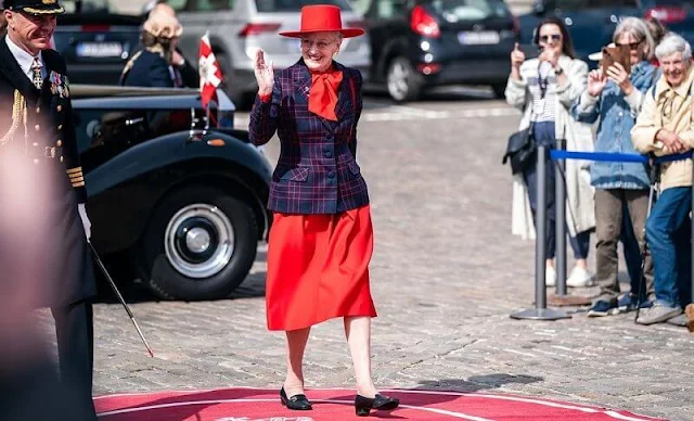 Queen Margrethe officially boarded the royal yacht Dannebrog. The Queen wore a red dress, and navy printed blazer, and red hat