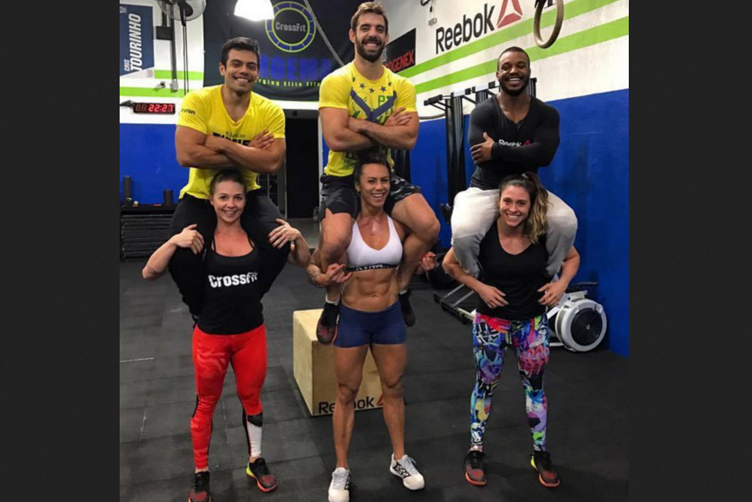 Strong CrossFit women Who Lifting and carrying Man's