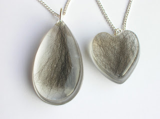 Teardrop and heart shaped resin pendants containing pet fur