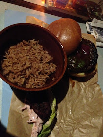 burger and bowl of rice on paper on a blue painted board