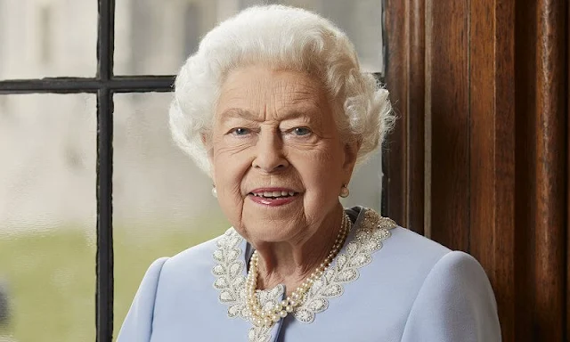 Queen Elizabeth wore a soft dove blue coat and dress, both designed by Angela Kelly