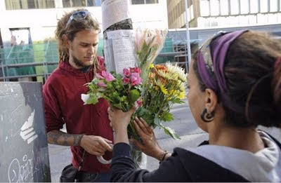 Mourners leaving flowers and letters for Darcy Allan Sheppard near where he was killed.