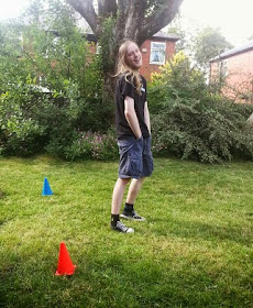 Boy in goal with cones in garden