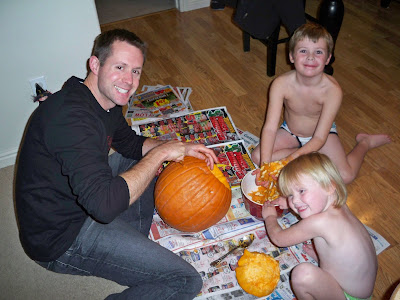 Naked children carving pumpkins