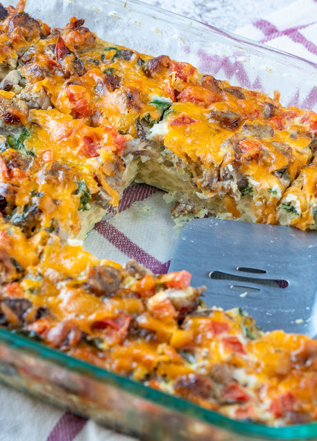 This breakfast casserole is great for Sunday morning breakfast, brunch or serve for the holidays! Tons of flavor from cheese, sausage, mushrooms, spinach, tomatoes, hash browns and onion. Simple to make and enough to feed the whole family!