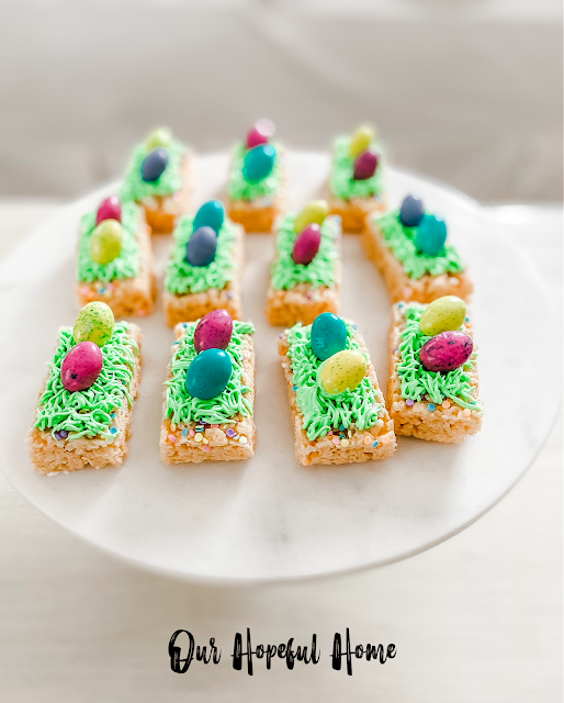 colorful M&M milk chocolate Easter egg candies on rice krispie treats with Easter grass icing