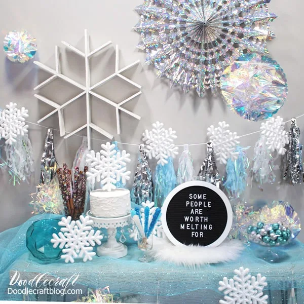 Winter wonderland or ice princess party with blue and silver decorations for the perfect Frozen themed party and holiday decor.
