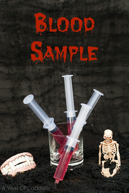 Halloween cocktails shots, blood sample, vanilla vodka, pomegranate juice, plastic syringe