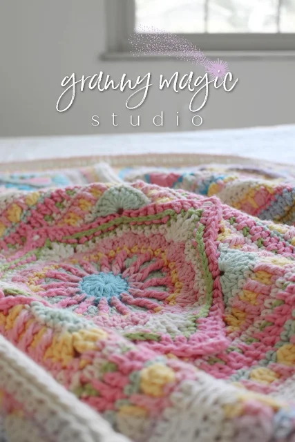 Crocheted square mixture of pink, blue, yellow, and green.