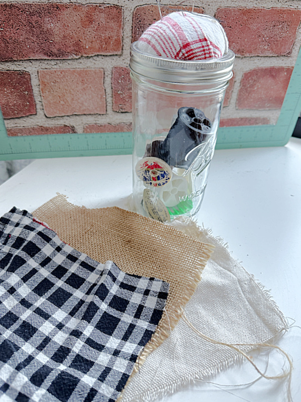 sewing jar and scraps of fabric