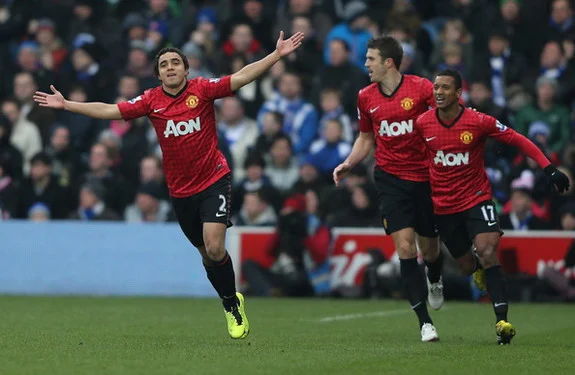 Rafael celebrates with Manchester United teammates after scoring against QPR